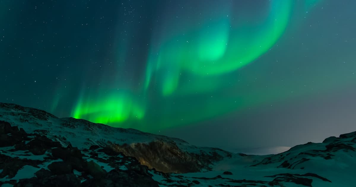Spectacular green northern lights over Norwegian wilderness near Alta